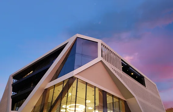 Universal Travel & Tours — modern headquarters at dusk